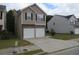 Two-story house with a two-car garage and neutral-colored siding at 6511 Grey Fox Way, Riverdale, GA 30296
