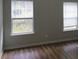 Bright bedroom with two windows and hardwood floors at 6511 Grey Fox Way, Riverdale, GA 30296