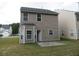 Two story house, rear view, with a small patio at 6511 Grey Fox Way, Riverdale, GA 30296