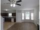Open living room with kitchen, wood floors, and neutral walls at 6511 Grey Fox Way, Riverdale, GA 30296