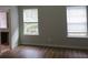 Bedroom with hardwood floors and two windows at 6511 Grey Fox Way, Riverdale, GA 30296