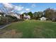 Spacious backyard with large grassy area, detached barn, and wooden fence at 2292 Acworth Due West Nw Rd, Acworth, GA 30101