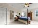 Bedroom with a wooden post bed, private bathroom access, and large windows at 2292 Acworth Due West Nw Rd, Acworth, GA 30101
