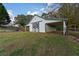 White barn with covered stalls and green accents at 2292 Acworth Due West Nw Rd, Acworth, GA 30101