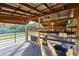 Barn stall with metal grates and cleaning tools at 2292 Acworth Due West Nw Rd, Acworth, GA 30101