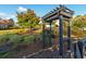 Landscaped garden with arbor and neatly trimmed bushes at 2292 Acworth Due West Nw Rd, Acworth, GA 30101