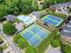 Community pool, tennis courts, and surrounding homes from above at 4201 Village Green Dr, Roswell, GA 30075