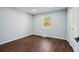 Simple bedroom with wood-look floors and closet at 1825 Niskey Lake Rd, Atlanta, GA 30331