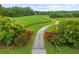 Aerial view of property showing long driveway leading to house and surrounding fields at 1171 Rocky Creek Rd, Locust Grove, GA 30248