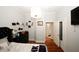 Bright bedroom with king bed, hardwood floors, and access to a hallway at 799 Hammond Dr # 116, Atlanta, GA 30328