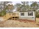 Newly constructed mobile home with wood deck and landscaped yard at 2253 Cole Dr, Social Circle, GA 30025