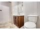 Simple bathroom with toilet, sink, and wood cabinets at 2253 Cole Dr, Social Circle, GA 30025