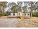 Single-wide manufactured home with a gravel driveway and wooden steps at 2253 Cole Dr, Social Circle, GA 30025