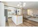 Modern kitchen with an island, white cabinets, and wood floors at 4701 Flat Shoals Rd # 54C, Union City, GA 30291