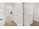 Hallway with multiple doors and neutral flooring at 110 Bonito Trl, Covington, GA 30016