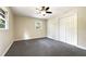 Well-lit bedroom with grey carpet and ceiling fan at 3811 Reynolds Rd, Douglasville, GA 30135