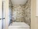 Updated bathroom with a shower/tub combo and modern tile at 3811 Reynolds Rd, Douglasville, GA 30135