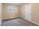 Well-lit bedroom with neutral walls and carpet flooring at 7047 Carolyn Cir, Lithia Springs, GA 30122