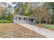 Front view of the house with a long driveway at 7047 Carolyn Cir, Lithia Springs, GA 30122