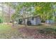 Side view of the house showcasing the backyard and shed at 7047 Carolyn Cir, Lithia Springs, GA 30122