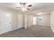 Large bedroom with neutral walls, ceiling fan and carpet flooring at 7047 Carolyn Cir, Lithia Springs, GA 30122