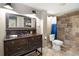 Basement bathroom with a vintage vanity, a walk-in shower, and blue shower curtain at 2002 Palmetto Dunes Ct, Johns Creek, GA 30097