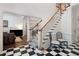 Grand entryway with checkerboard floor, staircase, and two blue chairs at 2002 Palmetto Dunes Ct, Johns Creek, GA 30097