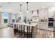 Eat-in kitchen with island seating, stainless steel appliances, and stylish light fixtures at 4025 Hosch Reserve Dr, Buford, GA 30519