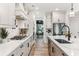 Modern kitchen featuring white cabinetry, quartz countertops, and a gas range at 4025 Hosch Reserve Dr, Buford, GA 30519