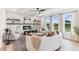 Living room with curved sofa, fireplace, and large windows at 4025 Hosch Reserve Dr, Buford, GA 30519