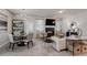 Open concept living and dining area with a fireplace and built-in shelving units at 5178 Longview Run, Decatur, GA 30035
