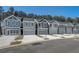 Row of gray townhomes with attached garages and driveways at 5178 Longview Run, Decatur, GA 30035