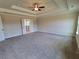 Large main bedroom with ceiling fan and ensuite bathroom access at 1117 Kingston Hill Dr, Loganville, GA 30052