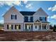 Two-story home with gray and blue siding, brick facade, and covered porch at 1451 Stephens View Dr, Loganville, GA 30052