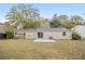 Ranch home with a spacious backyard, covered patio, and large grassy area at 6940 Kimberly Mill Rd, Atlanta, GA 30349