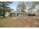 Ranch style home with carport and mature trees at 6940 Kimberly Mill Rd, Atlanta, GA 30349