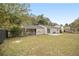 Ranch home with a spacious backyard, covered patio, and large grassy area at 6940 Kimberly Mill Rd, Atlanta, GA 30349