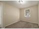 Well-lit bedroom with neutral walls and carpet at 6940 Kimberly Mill Rd, Atlanta, GA 30349