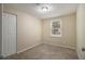 Simple bedroom with neutral walls and carpet at 6940 Kimberly Mill Rd, Atlanta, GA 30349