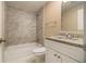 Updated bathroom with marble tile and granite vanity at 6940 Kimberly Mill Rd, Atlanta, GA 30349