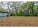 Large backyard with spacious grassy area, surrounded by trees and a privacy fence at 2191 Miriam Ln, Decatur, GA 30032