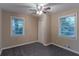 Well-lit bedroom featuring two windows and ceiling fan at 2191 Miriam Ln, Decatur, GA 30032