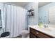 Clean bathroom with shower/tub combo, vanity, and linen storage at 1571 Long Acre Dr, Loganville, GA 30052