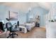 Bedroom with light blue walls, a bed, and a workspace at 1571 Long Acre Dr, Loganville, GA 30052