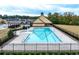 Community swimming pool with a pavilion and surrounding fence at 1571 Long Acre Dr, Loganville, GA 30052