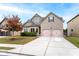 Two-story house with two car garage and manicured lawn at 1571 Long Acre Dr, Loganville, GA 30052