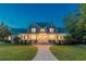 Two-story home with a large front porch and stone walkway at dusk at 8850 E Carroll Rd, Winston, GA 30187