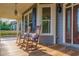 Relaxing front porch with rocking chairs, offering a peaceful view of the surroundings at 8850 E Carroll Rd, Winston, GA 30187