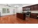 Open concept kitchen with island, stainless steel appliances, and hardwood floors at 2942 Ashlyn Pointe Dr, Atlanta, GA 30340