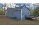 Side view of gray house with deck and landscaping at 1815 River Ne St, Conyers, GA 30012